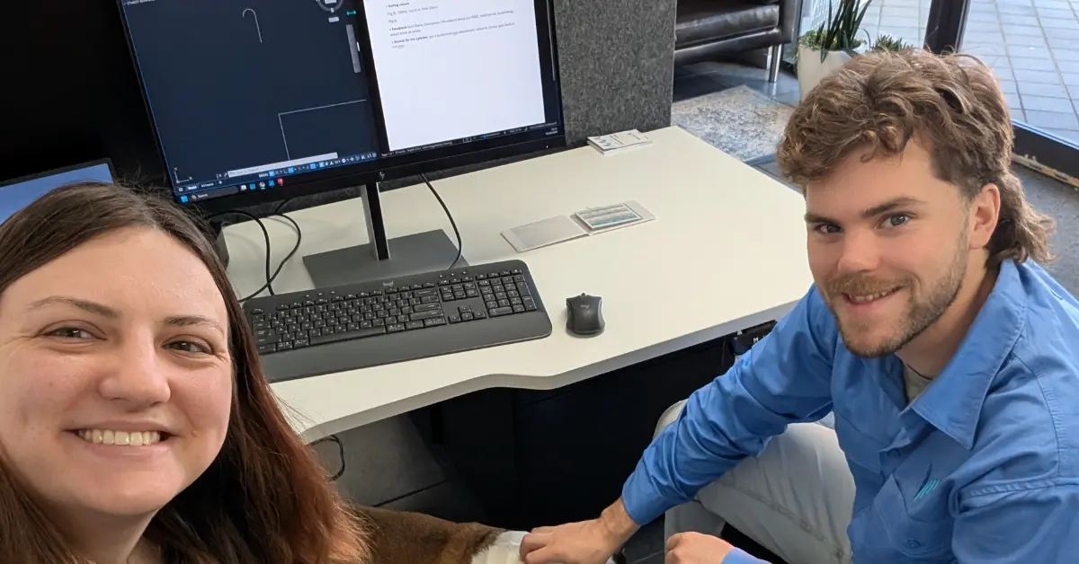 Emma och anton, studerande till drift- och underhållstekniker framför ett skrivbord på sin LIA-plats.