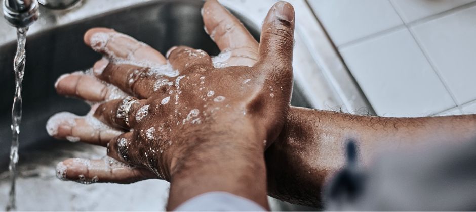 Inzoomad bild på intvålade händer i en vask.
